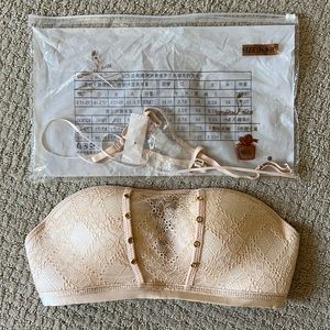 Brand new in packaging strapless bra with loving hands to cradle your girls!